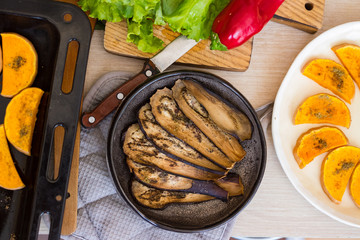 Baked aubergine, eggplant. Roasted with spices on plate. Vegan food