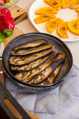 Baked aubergine, eggplant. Roasted with spices on plate. Vegan food