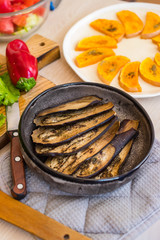 Baked aubergine, eggplant. Roasted with spices on plate. Vegan food