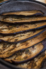 Baked aubergine, eggplant. Roasted with spices on plate. Vegan food