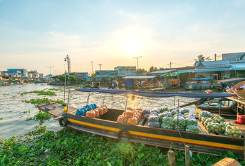 Fototapeta na wymiar Agricultural products transported on boats to trade in floating markets in the Mekong Delta of Soc Trang, Vietnam