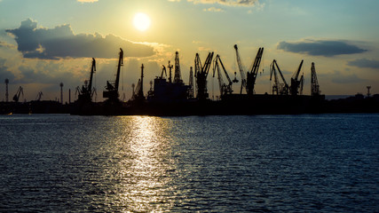 Colorful sunset over sea port and industrial cranes, Varna, Bulgaria