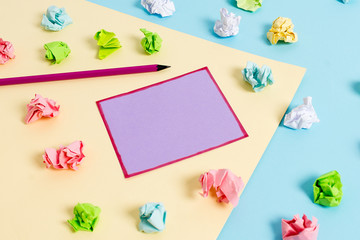 Colored crumpled papers empty reminder blue yellow background clothespin