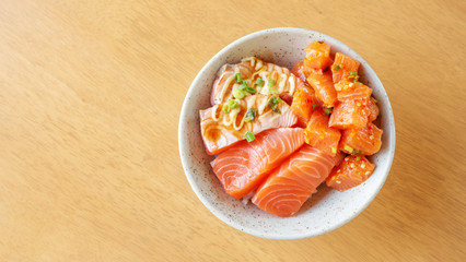 Fresh Sashimi salmon and rice on a wooden table.