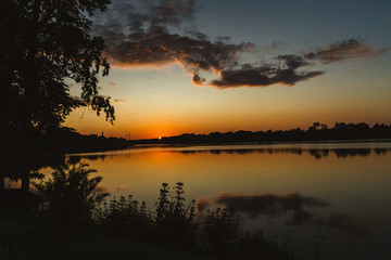 The orange light of a beautiful sunset is reflected in the eagle creek at Marinette,WI.