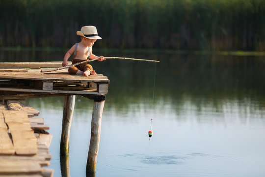 little boy fishing on the lake