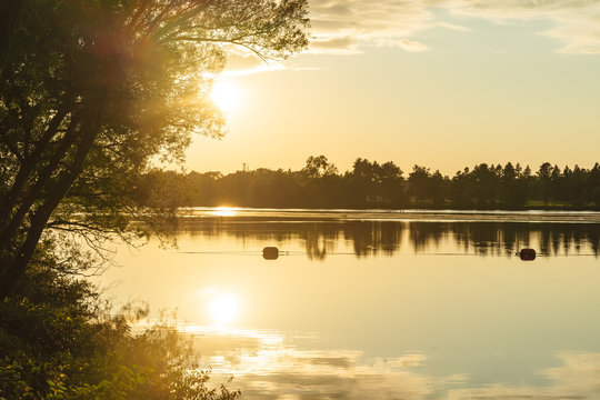 The orange light of a beautiful sunset is reflected in the eagle creek at Marinette,WI.