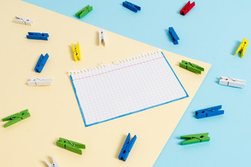 Colored clothespin paper empty reminder yellow blue floor background office
