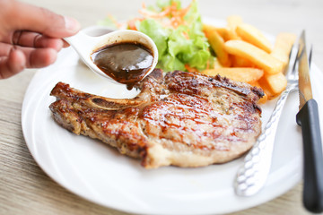 Grilled meat, Porkchops steak with pepper sauce and salad.