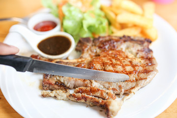 Grilled meat, Porkchops steak with pepper sauce and salad.