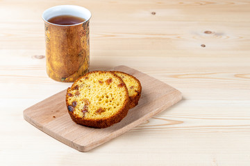 Breakfast in the workshop. Homemade cakes with cottage cheese and mug hot drink on a workbench.