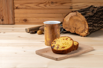 Breakfast in the workshop. Homemade cakes with cottage cheese and mug hot drink on a workbench.