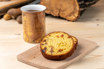 Breakfast in the workshop. Homemade cakes with cottage cheese and mug hot drink on a workbench.