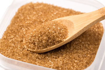 Brown sugar close texture in a sugar bowl with a spoon. close up