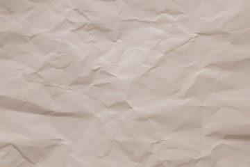 Crumpled vintage paper background. Texture of creased beige sheet. Wrinkled page, pattern. Copy space. Light pink wrinkle cardboard surface. Carton surface.