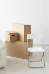 Boxes with things during the move of residents to a new apartment. The concept of home buying and the hassle of moving.