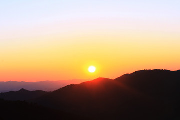 Obraz premium Sunset in sky and cloud, beautiful colorful twilight time with silhouette of mountain.