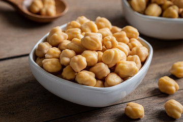 Cooked chick peas in white bowl.
