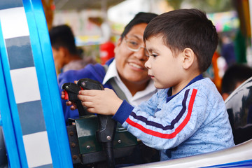 Obraz na płótnie Canvas Native american man with his little son in the amusement park.