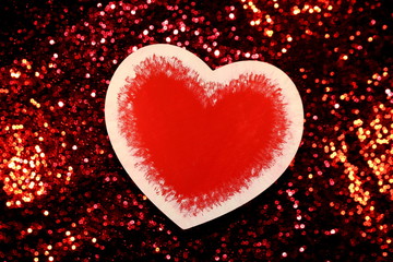 Fototapeta premium beautiful red heart on red shiny background