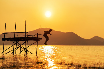 Fototapeta premium Boy jumping into lake.