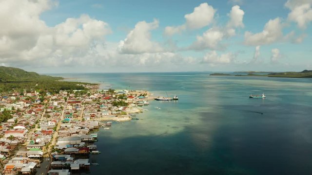 Passenger port with ferries and cargo ships on the island of Siargao,aerial view. Dapa Ferry Terminal. Siargao, Philippines.
