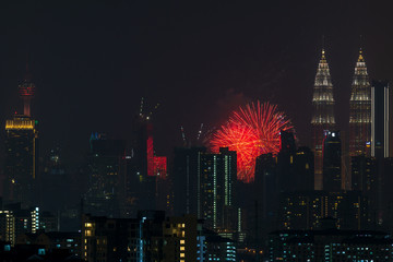 Fototapeta na wymiar Fireworks explode over the Petronas Twin Towers during the midnight display on 45th anniversary of Petronas at downtown Kuala Lumpur.
