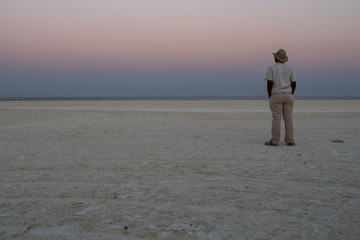 Dusk in Makgadikgadi Salt Pan - Black Man Gazing at Horizon © Dietmar