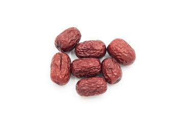 Close-up of a small pile of Chinese red dates on a white background