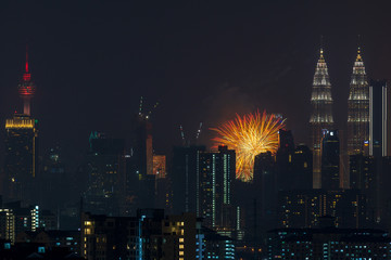 Fototapeta na wymiar Fireworks explode over the Petronas Twin Towers during the midnight display on 45th anniversary of Petronas at downtown Kuala Lumpur.