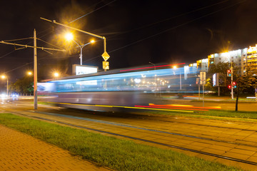 The motion of a blurred tram in the evening.