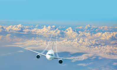 Aircraft flies high over the city and and sea coast -  White passenger airplane in the clouds at...