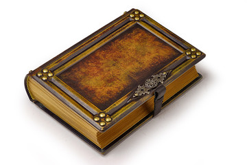 Aged large leather book with carved frame, metal pins in the corners, decoration as a door handle...