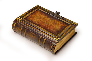 Aged large leather book with carved frame, metal pins in the corners, decoration as a door handle and gilded paper edges.