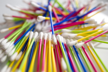  heap of colorful ear sticks on a white abstract background