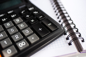 calculator and pen on a white background