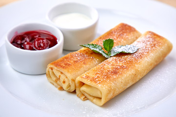 pancakes with sour cream and berry sauce
