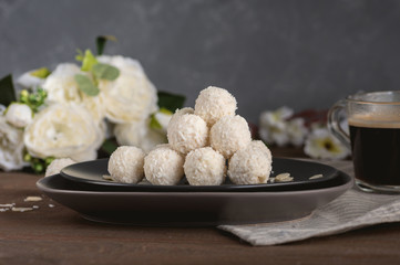 Homemade coconut candies on wooden table
