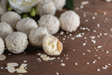 Homemade coconut candies on wooden table