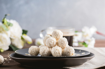Homemade coconut candies on wooden table