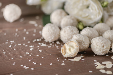 Homemade coconut candies on wooden table