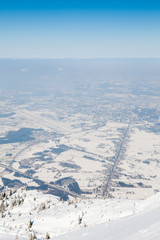 Fototapeta na wymiar Untersberg Summit. The view from the summit of Untersberg mountain in Austria. The mountain straddles the border between Germany and Austria and in the background can be seen the city of Salzburg.