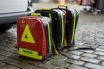 emergency cases of the mobile ambulance on cobblestone pavement in the rain at a large event in the...