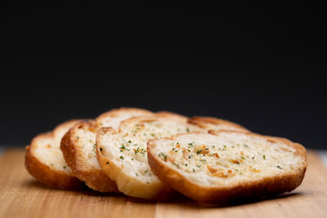 Slice garlic bread on wooden table