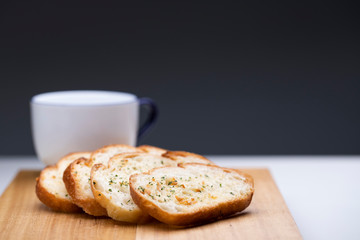 Slice garlic bread on wooden table