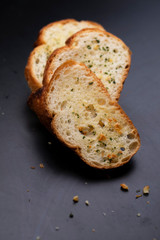 Slice garlic bread on black table