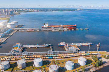 Aerial view large port oil loading terminal with large storage tanks. Railway infrastructure for...