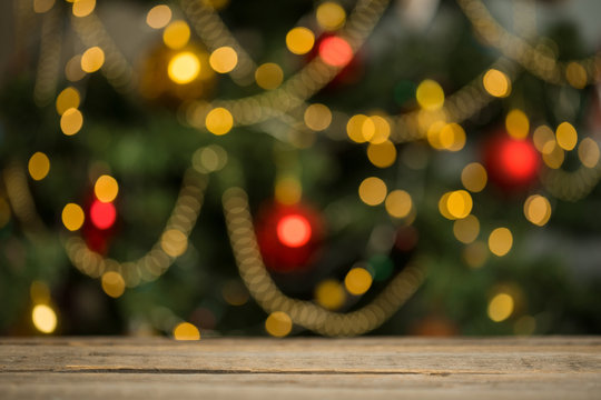 rustic wood table in front of christmas light night, abstract circular bokeh background