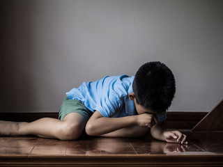 Neglected Lonely Child Leaning At Room corner with sadness and unhappy. Face-palm concept.