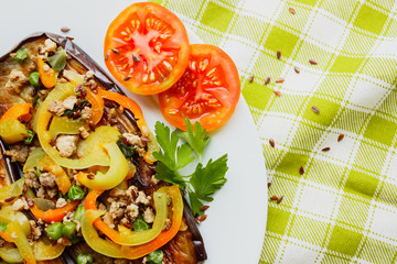 Fried eggplants with minced meat and different vegetables, flaxseed decoration, finished dish